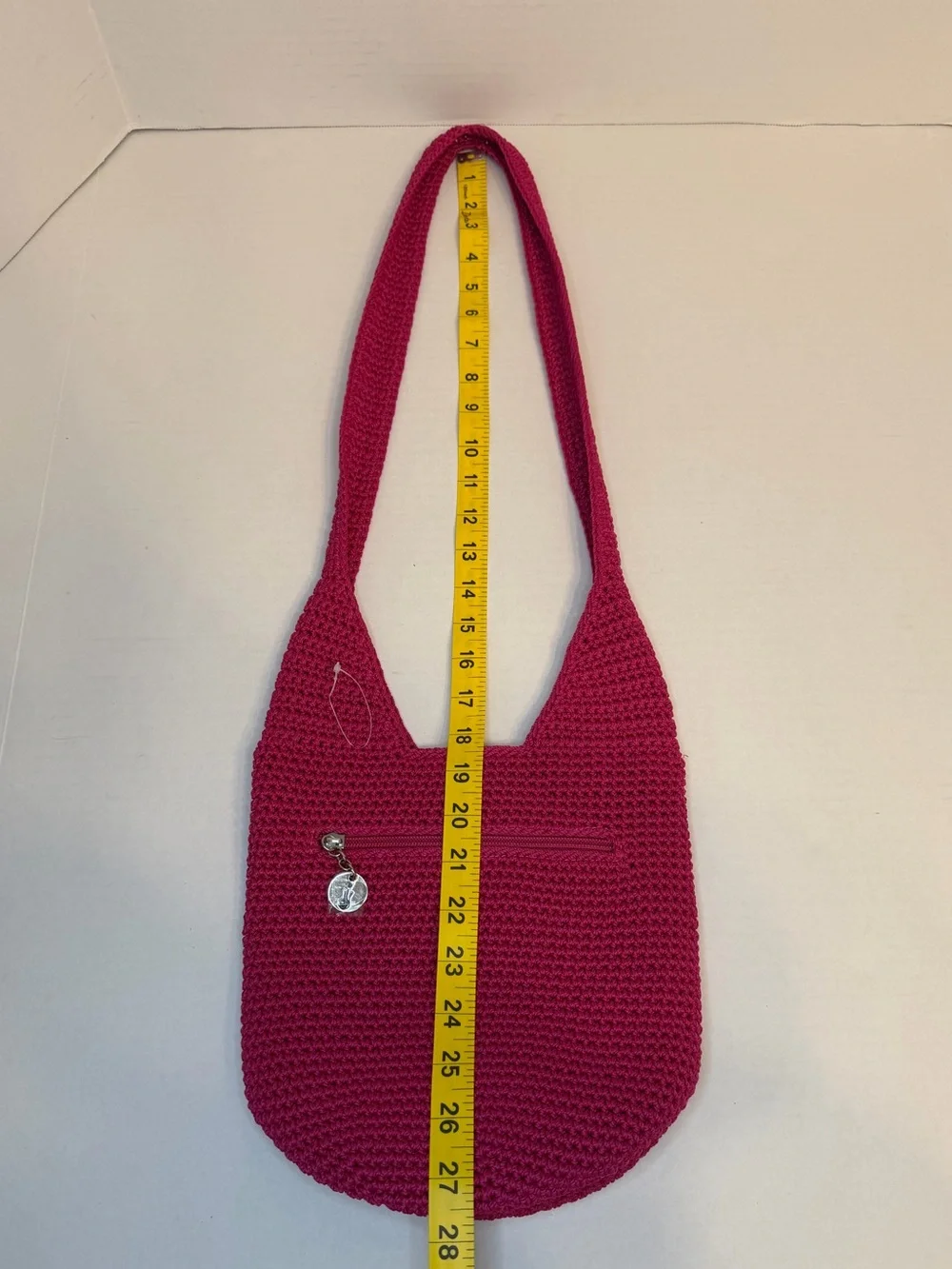 The Sak raspberry, pink handcrafted crochet hobo shoulder bag